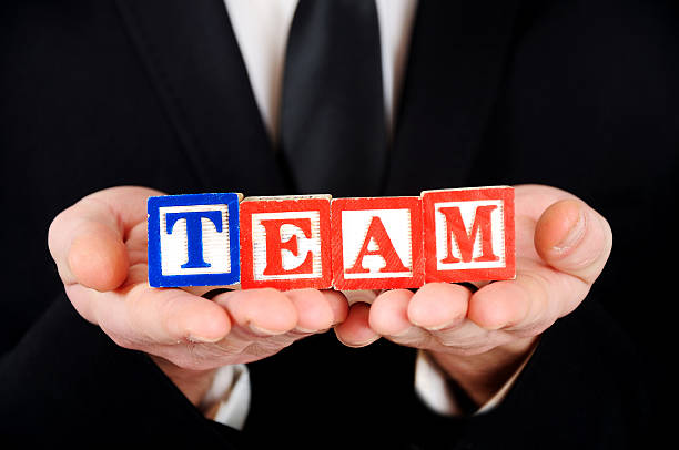istock Businessman holding cubes reading - Team 468490146