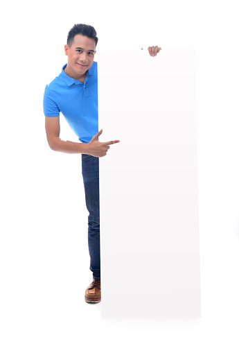 Young man holding blank billboard isolated on white background