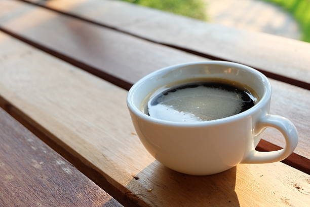 istock Coffee cup on wooden background in the garden 468491314