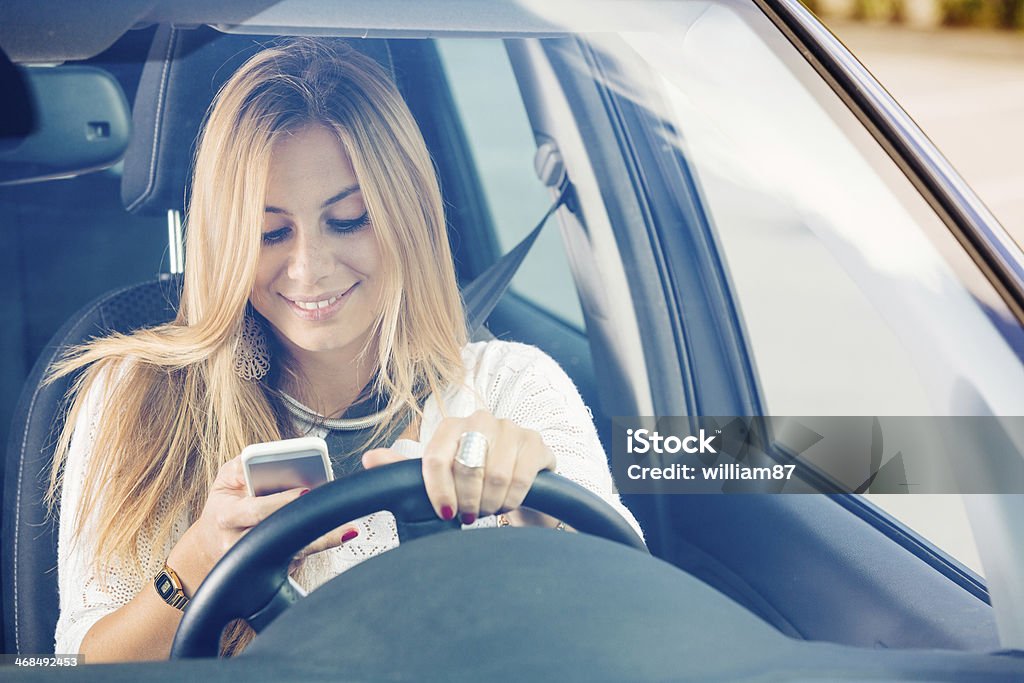Young Woman Sending Messages while Driving Adult Stock Photo