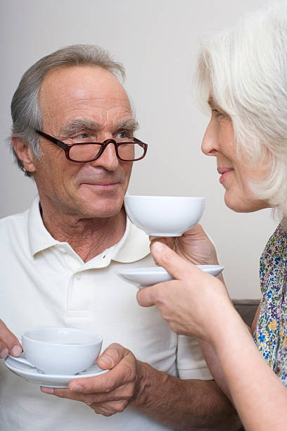 istock Senior couple drinking coffee together close up 468495870