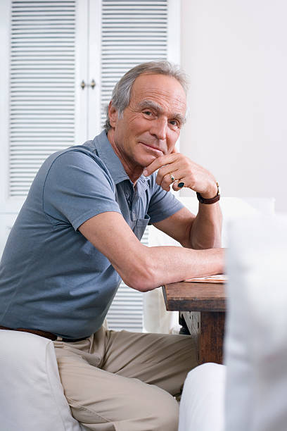 istock Senior man sitting, table, hand on chin 468496880