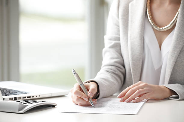 istock Businesswoman with documents and calculator 468496990