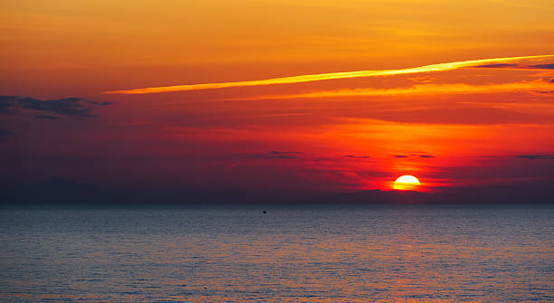 istock boat silhouette alone in the sea under a scenic sky 468504746
