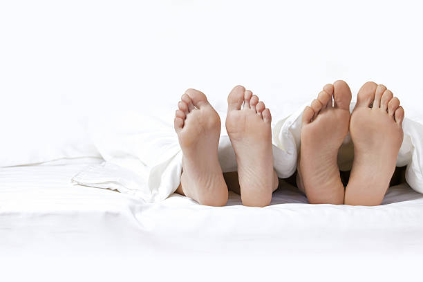 istock Couple's feet on the bed 468508746