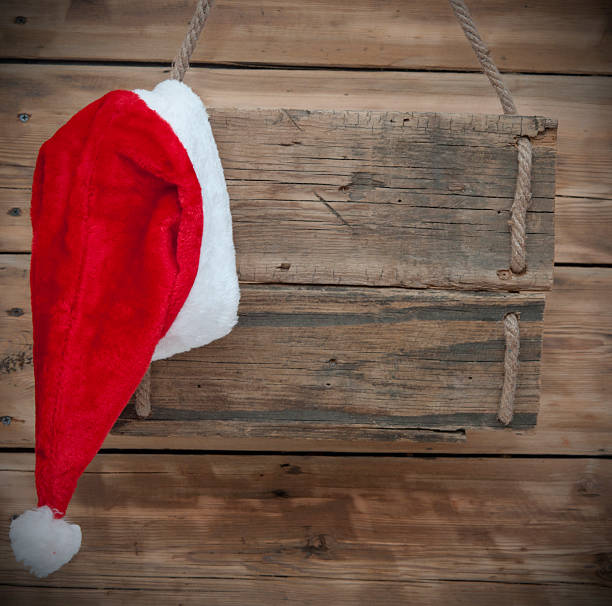 istock Weathered wooden sign with Santa hat 468511759