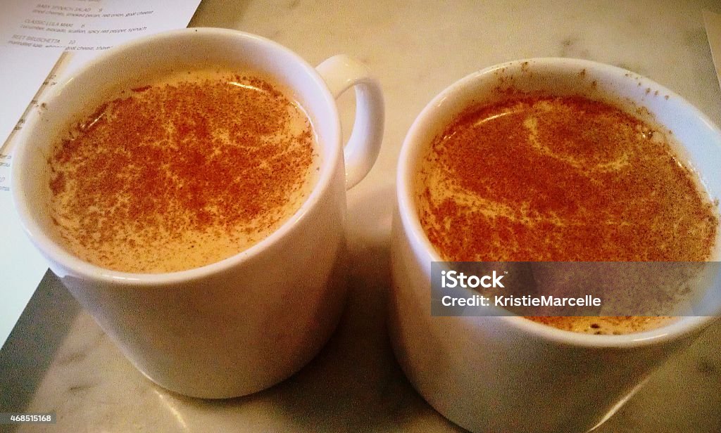 Hot Cocoa Drinks Hot cocoa drinks topped with cinnamon--the perfect way to start an autumn day. 2015 Stock Photo