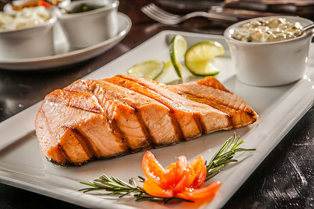 Salmon Salmon served at the table grilled salmon stock pictures, royalty-free photos & images