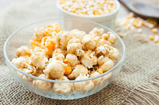 istock bowl of popcorn on a wooden table, caramel popcorn 468517128