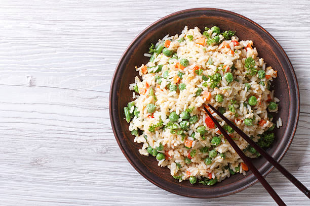 istock fried rice with green peas and eggs horizontal top view 468522816