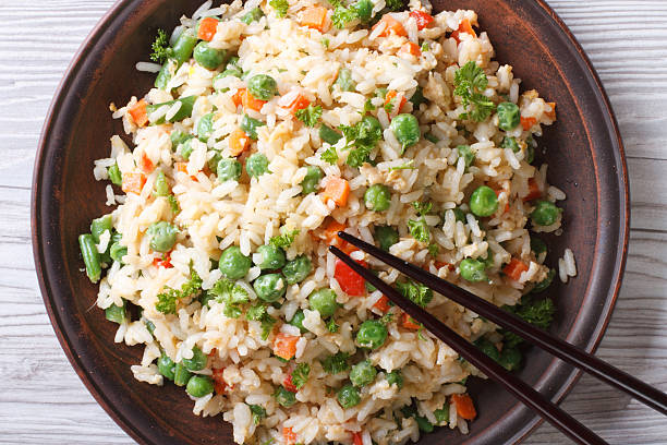 istock Asian fried rice with egg and vegetables top view horizontal 468522932