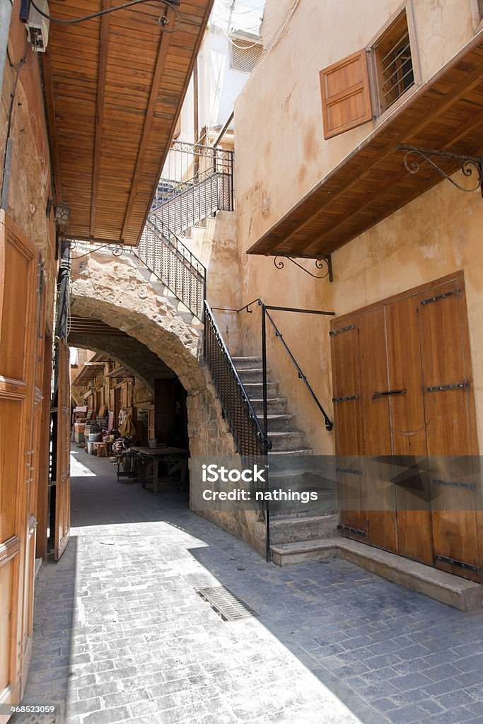 Old street in Saida, Lebanon Old street with sandstone arc and wooden closed doors in downtown of Saida, Lebanon Ancient Stock Photo