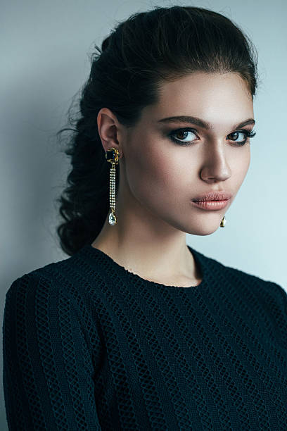 Portrait of a nice looking woman with beautiful earings. Professional make up