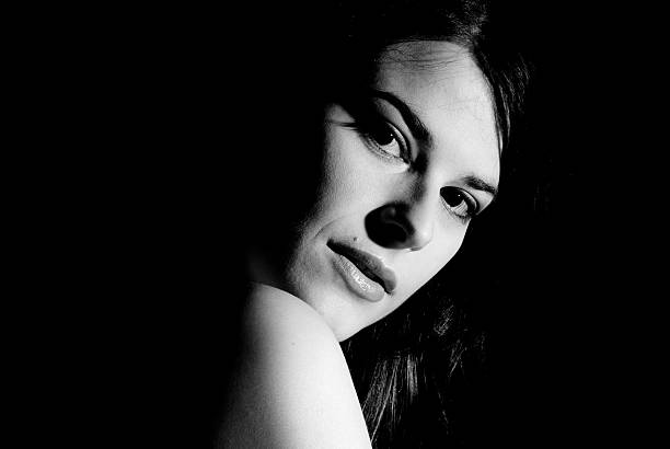 istock Woman looks over shoulder with strong stare 468525585