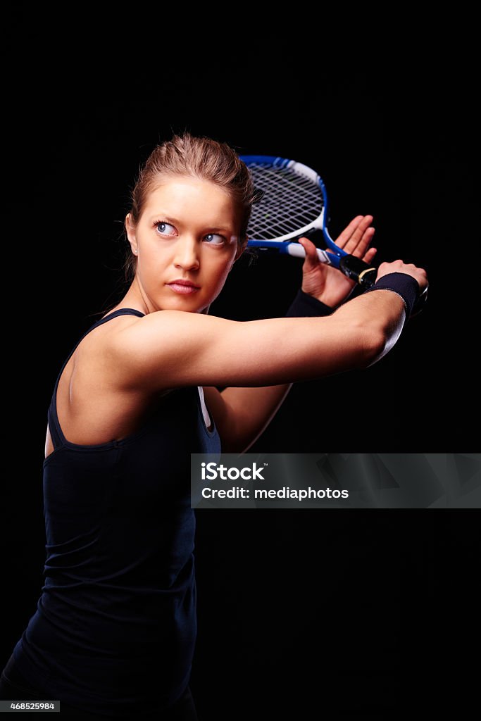 Determined tennis player Female tennis player ready to hit the ball 2015 Stock Photo