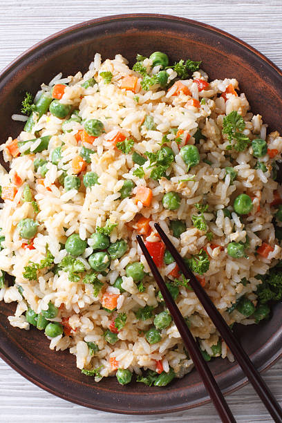 istock Asian fried rice with egg and vegetables top view vertical 468526196