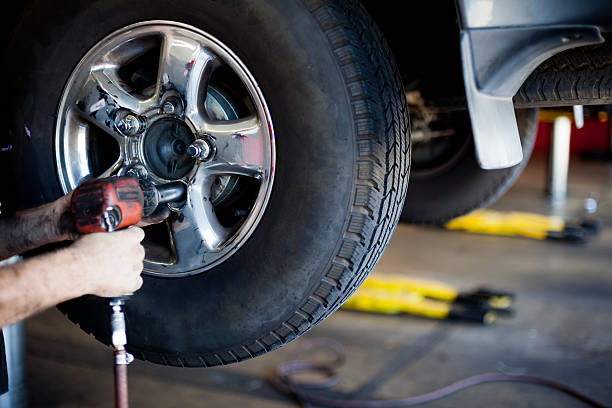 istock Mechanic Taking Tire off with Power Tool 468526556