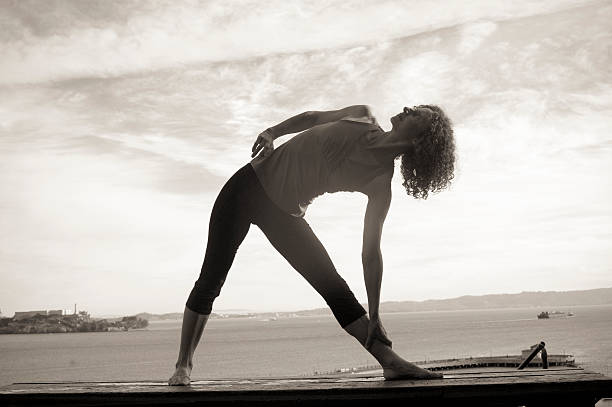 istock Silhouetted woman stretching 468526582
