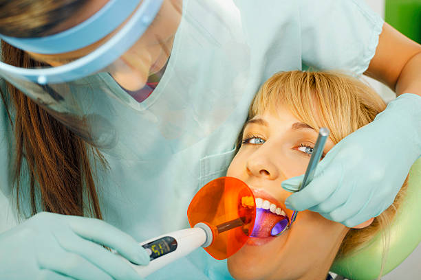 istock Dentistry  Dentist working  Ultraviolet Light Cure Fillings  Teeth Dental Process 468532846