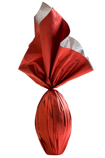 Brazilian Easters egg , wrapped in red paper, on a white background.