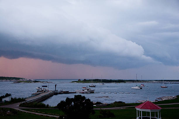 Rye, NH, USA - August 6, 2014: Threatening storm clouds pass overhead as boats wait out a summer storm in Gosport Harbor off of Star Island.