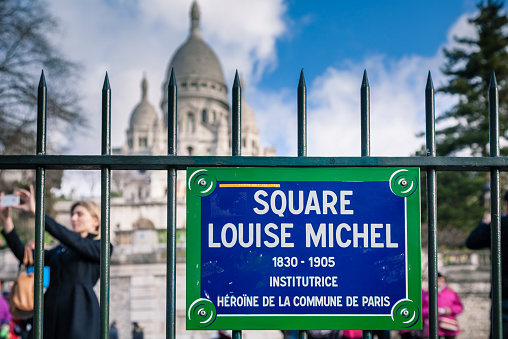 Paris, France - March 30, 2015: Ouf of focus tourist taking a photo in front of Montmartre in Paris