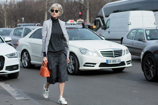 Paris, France - March 7, 2015: Fashion Blogger Linda Tol wears Louis Vuitton bag, LK Bennett jacket, Dries Van Noten trousers, Uniqlo sweater, Adidas shoes, and Mykita sunglasses on day 5 of Paris Collections.