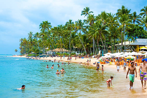 Bahia, Brazil - November 16, 2014: People enjoy a sunny day at Praia do Forte (Forte Beach) in Bahia, Brazil
