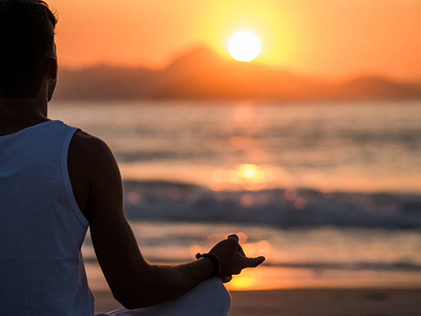 istock Rear view of a man in Lotus position at beach. 468542802