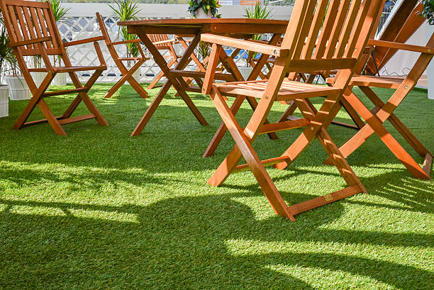 istock wooden chairs and table on the green grass 468543252