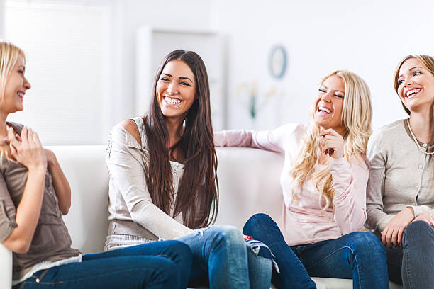 istock Cheerful young women sitting at home and talking. 468551578