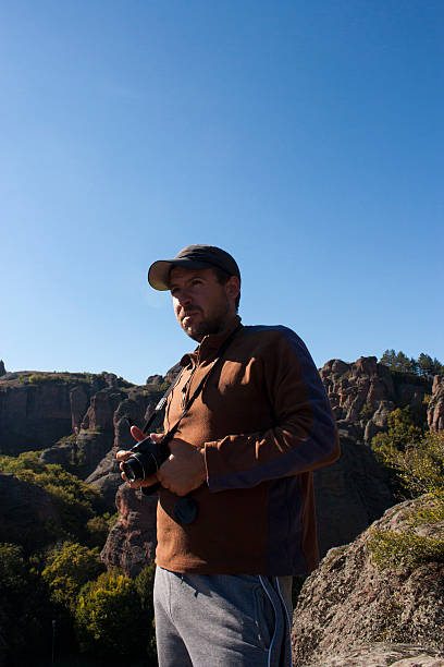 istock Man with camera make pictures on amazing rock landscape 468552578