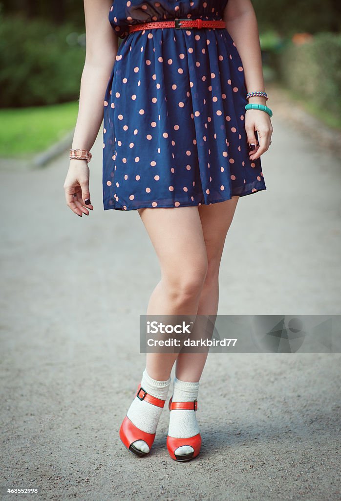 Red sandals with white socks on girl legs fifties style Red sandals with white socks on girl legs in fifties style outdoor Sandal Stock Photo