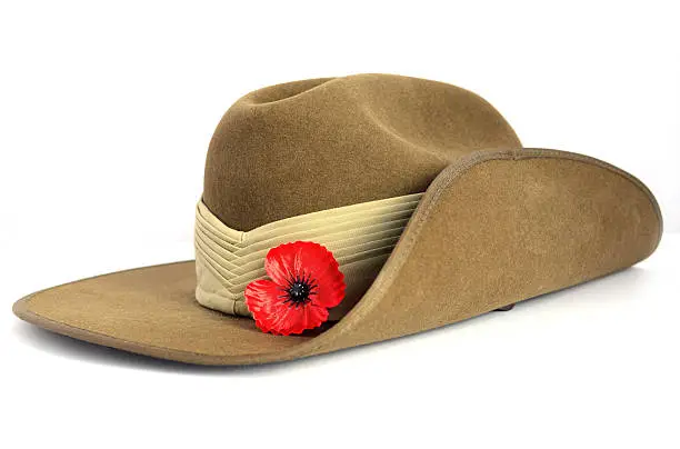 Anzac Day army slouch hat with red poppy on white background.