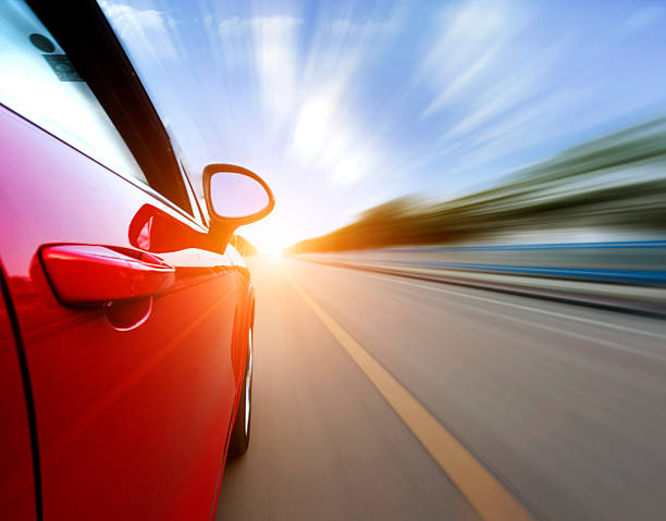 istock Red car on the road with a motion blur background 468553619