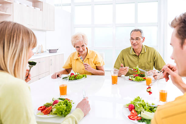 istock Happy family eating salad. 468558736