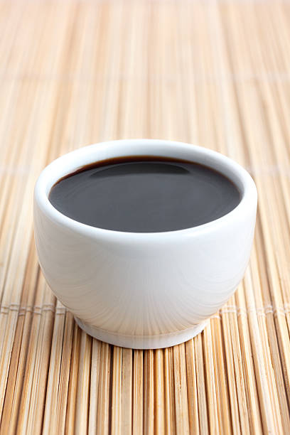 istock Soja sauce in small white dish. On bamboo mat. 468559066