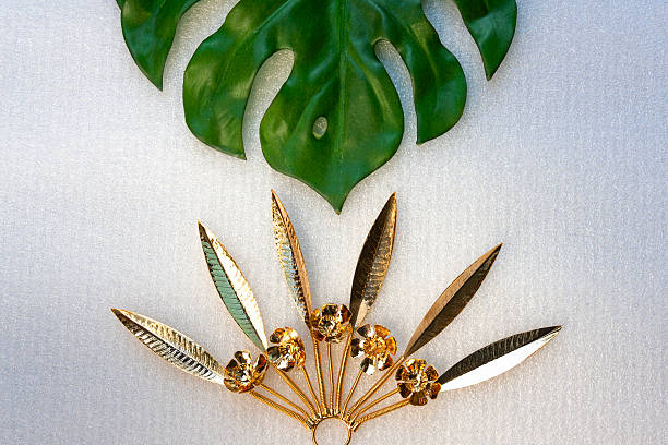 istock Green leaf and Golden flowers on the white background 468559558
