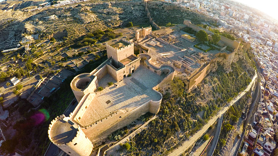 Defense Walls and Towers of Ancient fortress Alcazaba of Almeria, Spain - aerial shot including panoramic view of the Mediterranean Almeria city
