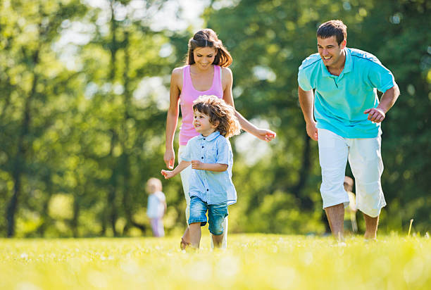 istock Cheerful family running in park. 468560336