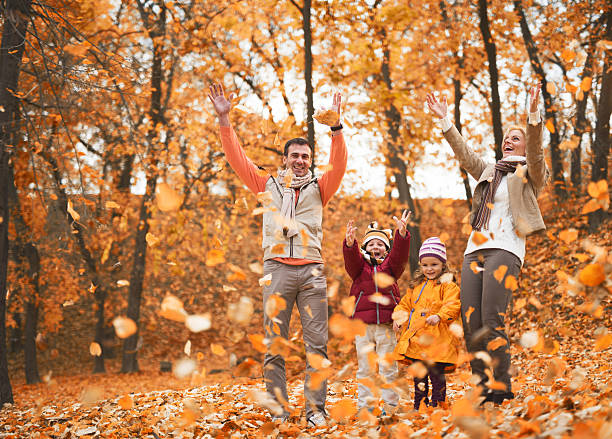 istock Cheerful family having fun in autumn park. 468560564