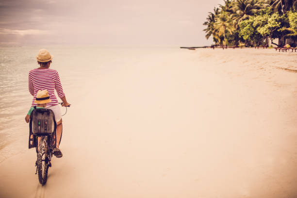 istock Mother and son exploring the beach at the bicycle 468560820