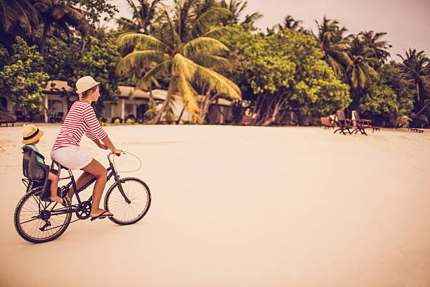 istock Mother and son exploring the beach at the bicycle 468560822