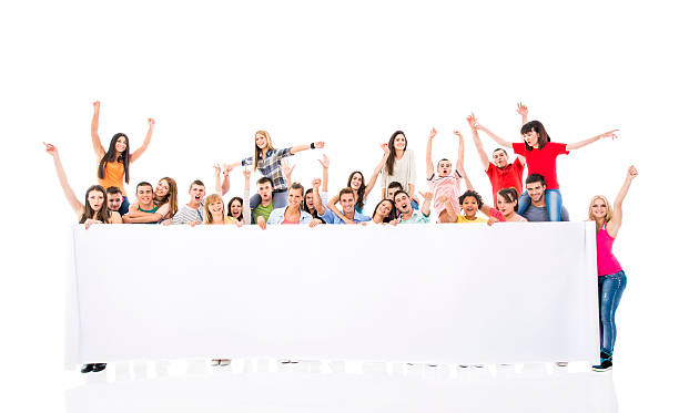istock Large group of cheerful young people holding white banner. 468563324