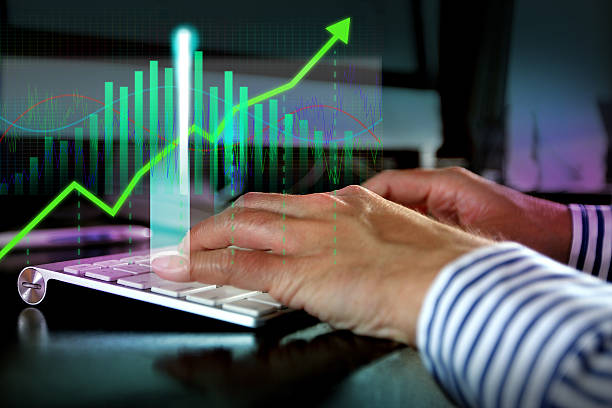 istock Hands typing on keyboard with finance graph overlay 468565142