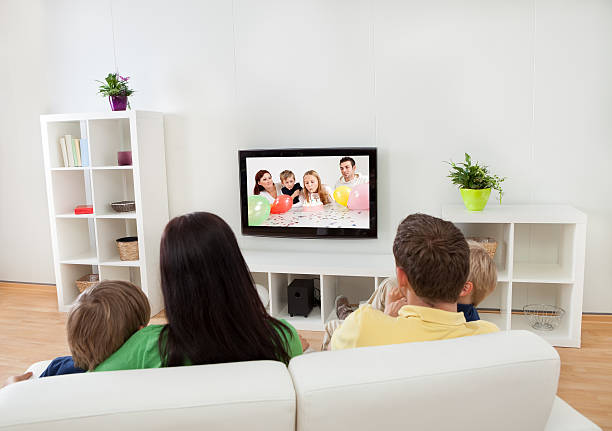istock Young family watching TV 468566723
