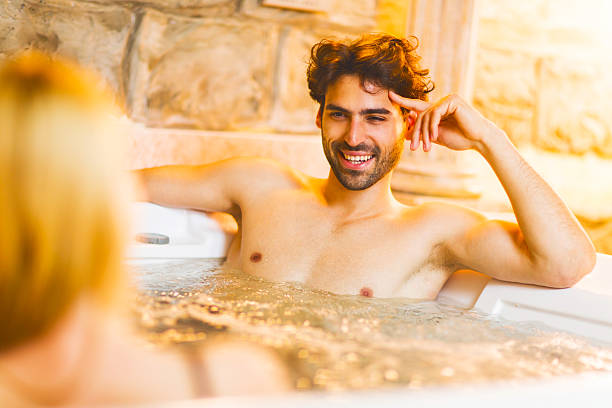 istock Happy man communicating with his girlfriend in a hot tub. 468568740