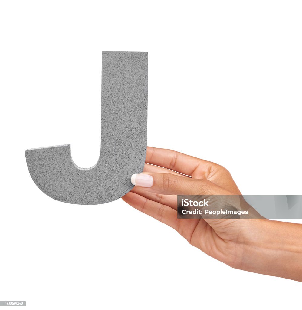 The letter "J" A young woman holding a capital letter "J" isolated on a white backgroundhttp://195.154.178.81/DATA/i_collage/pi/shoots/785435.jpg 2015 Stock Photo