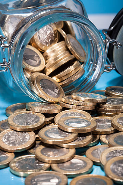 istock Euro Coins Spilling From Jar 468569559