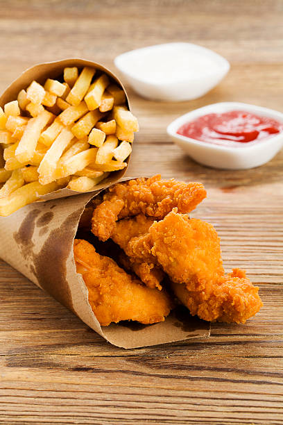 istock Nuggets and chips served in a paper bag with dips 468572508